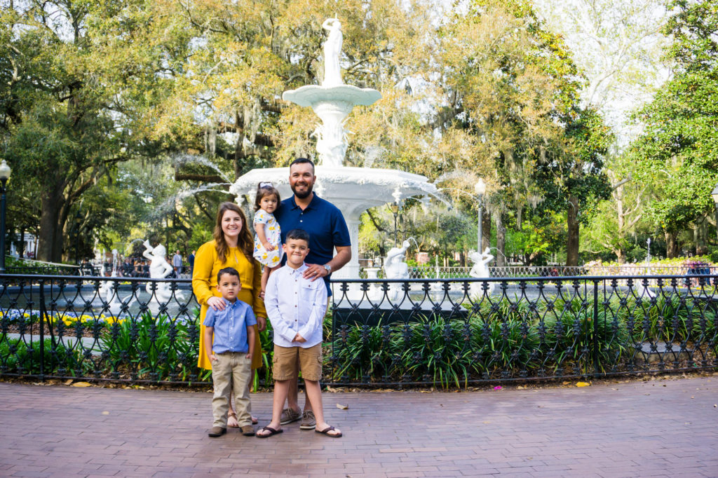 family at Forsyth Park in front of fountain