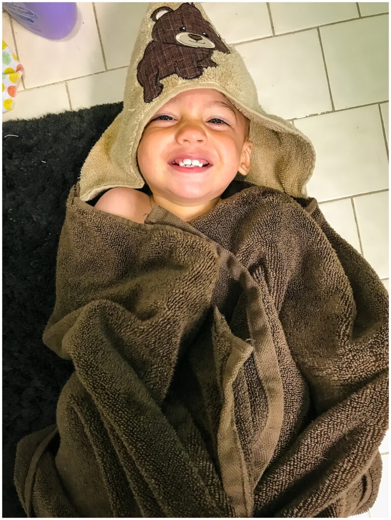 little boy wrapped in hooded towel