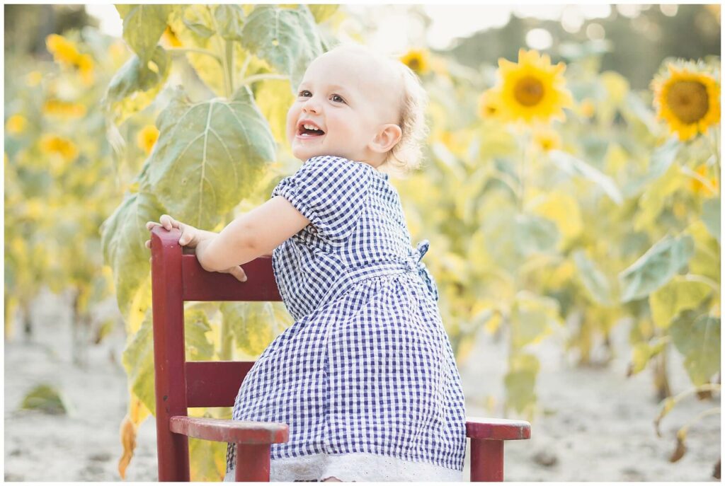baby girl in a sunflower field