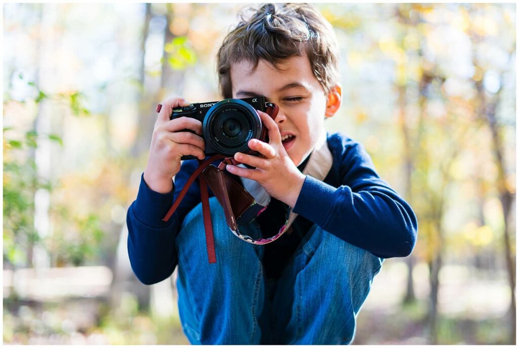 little boy taking a photo 