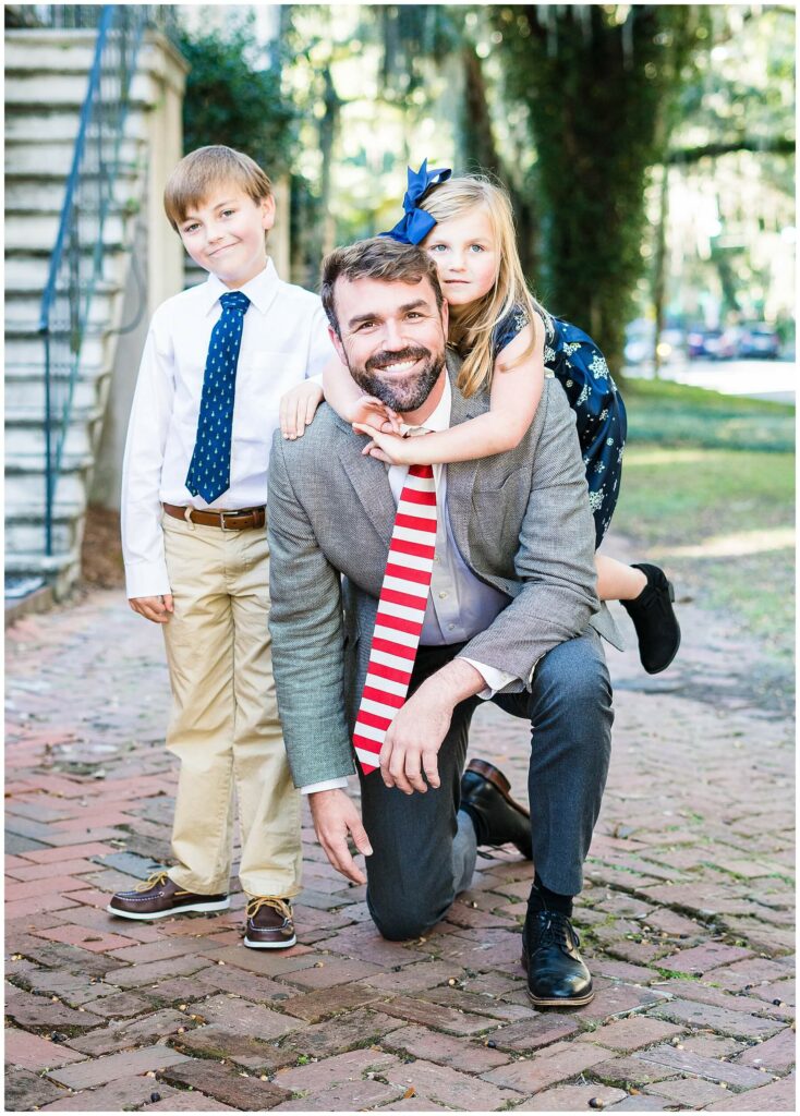 dad with kids on brick sidewalk