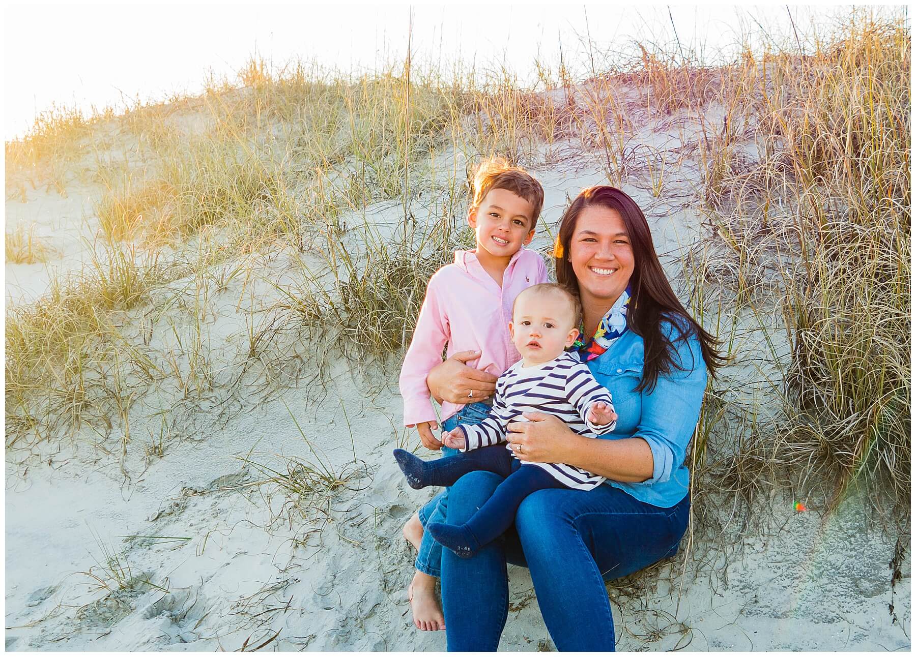 mom and two kids on beach at sunset