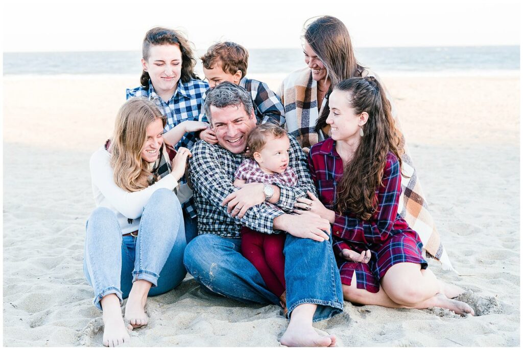 family of 7 tickling dad on beach