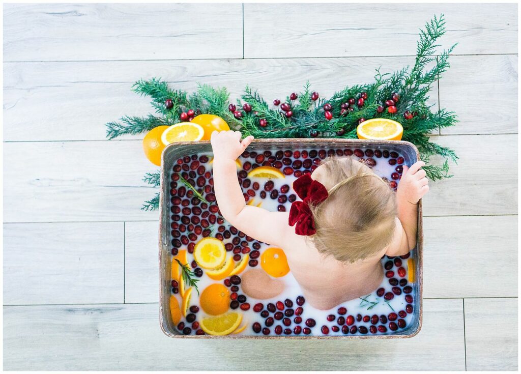 baby in milk bath with cranberry and orange