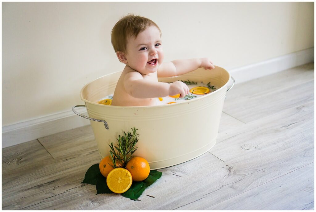 baby in an orange milk bath