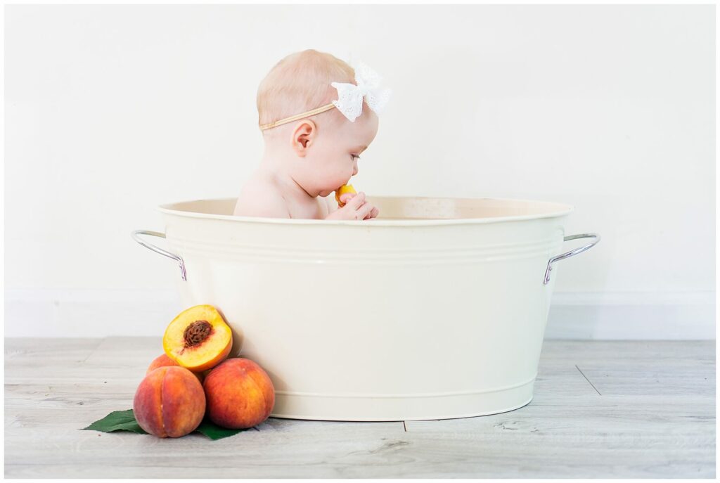 baby in peach milk bath