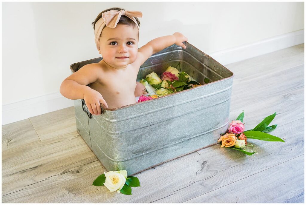 baby in rose flower bath