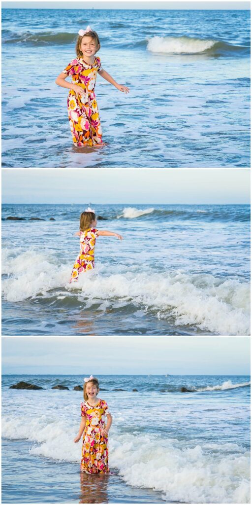 little girl in bright dress playing in ocean