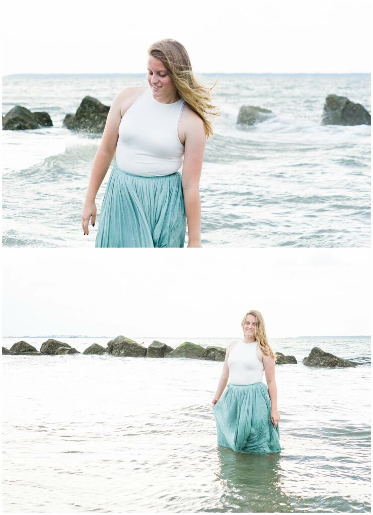girl in long green skirt standing in ocean