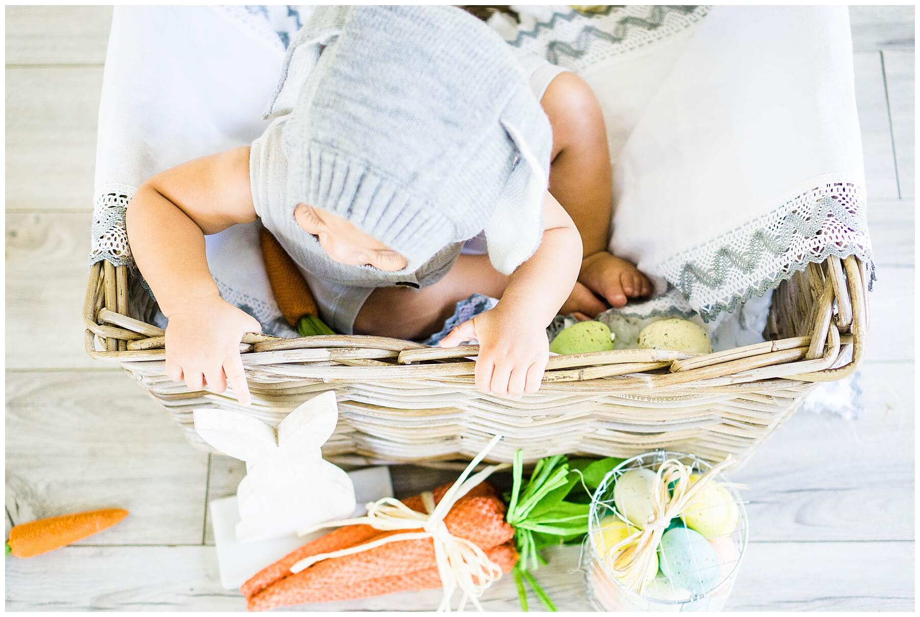 baby in a basket with easter decor