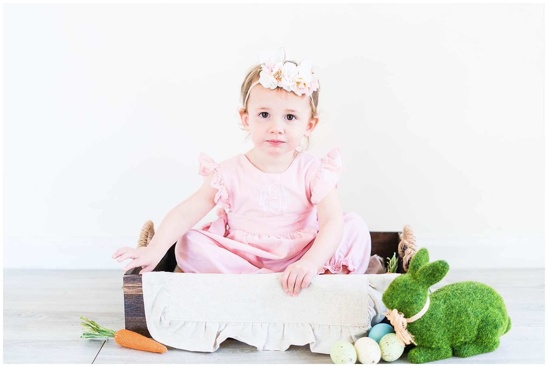 little girl in box with easter decor