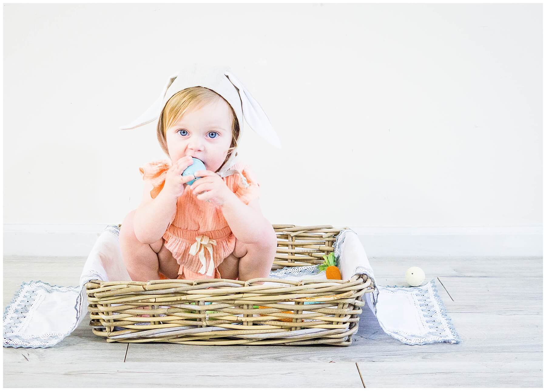 baby girl in basket with easter decor