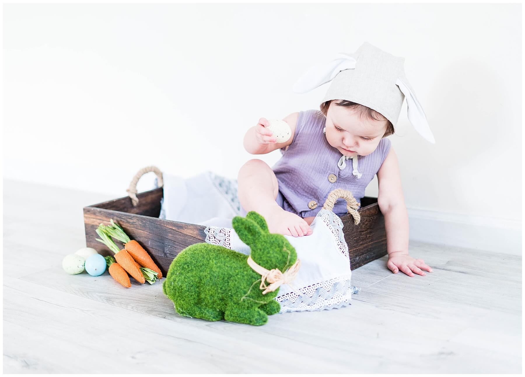 baby girl in box with easter decor