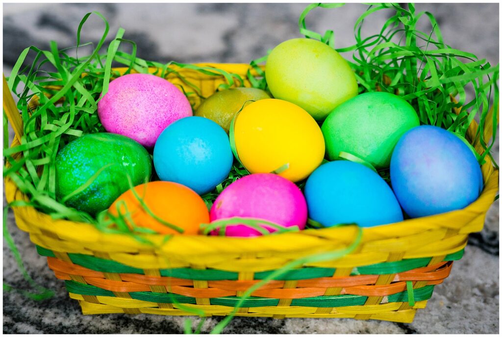 a basket full of dyed eggs