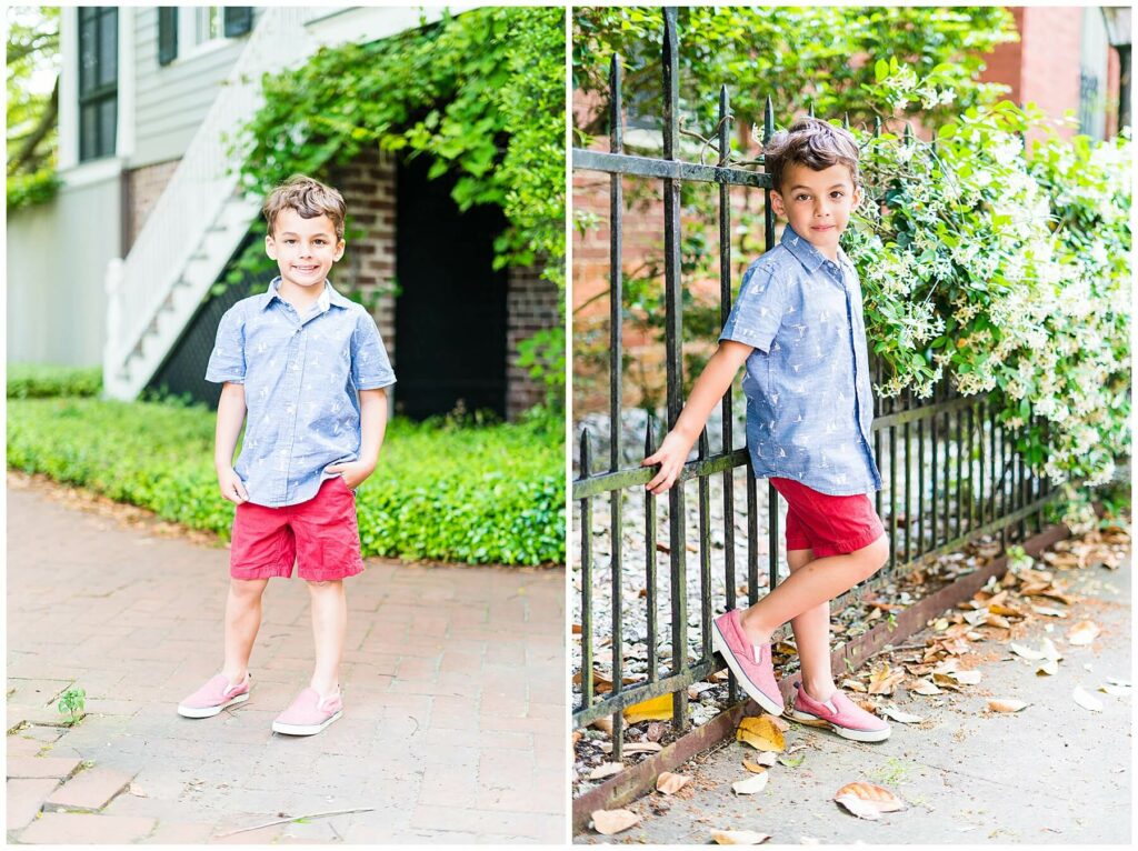 little boy in red shorts and a blue button down posing in downtown Savannah's Pulaski square