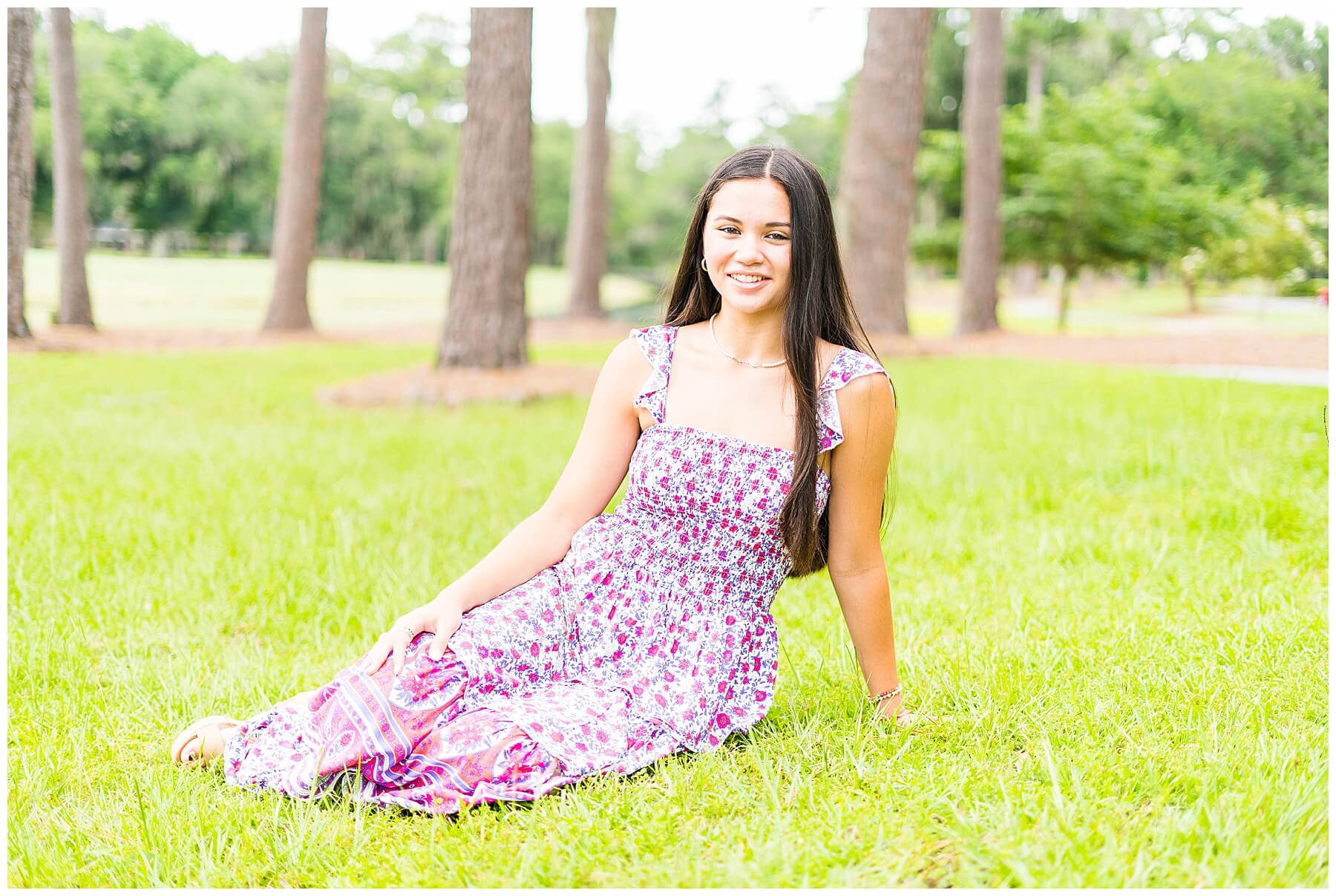 savannah high school senior girl sitting in grass posing for senior pictures