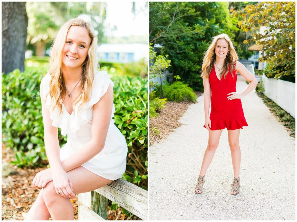 highschool senior posing sitting on a fence in a white romper and standing in a gravel driveway in a red dress