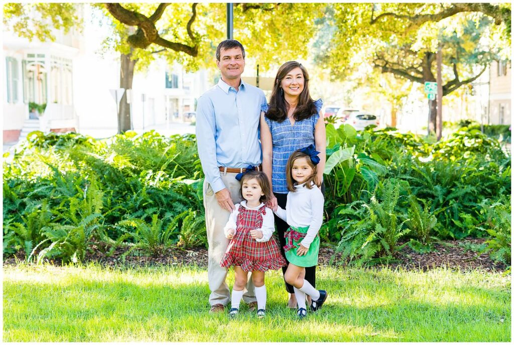 family of four in downtown Savannah Georgia posing for a family photo