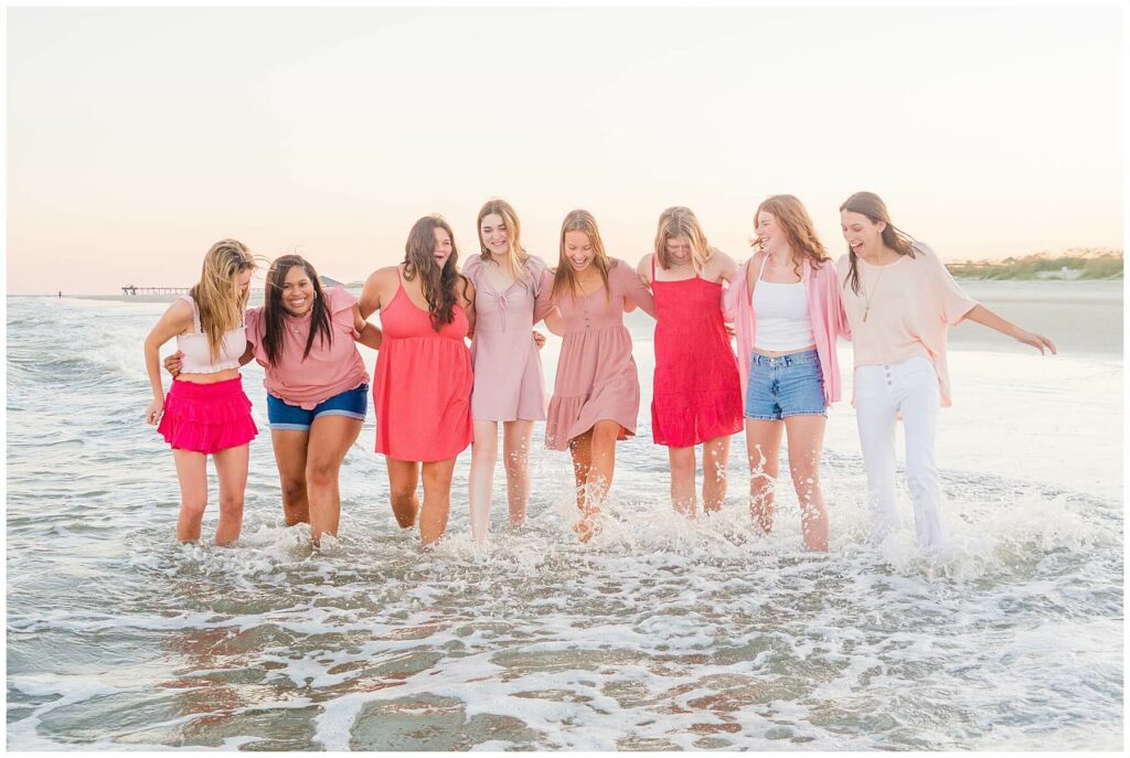 high school senior girls wearing pink at the beach for senior pictures 