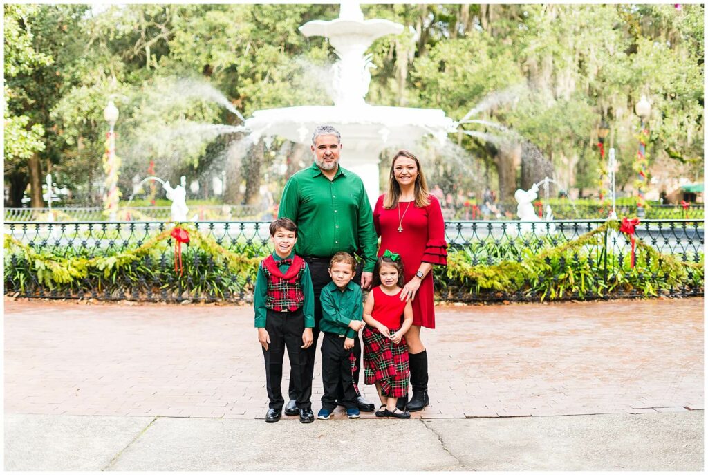 family of five standing in front of forsyth park fountain in downtown savannah
