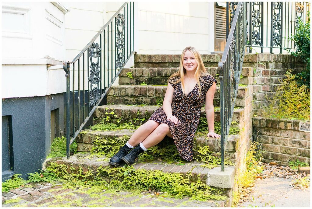 savannah high school senior sitting on moss covered steps in downtown savannah for senior pictures