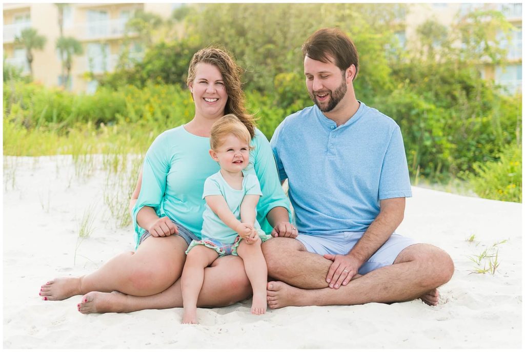 family of three on the beach for family photos