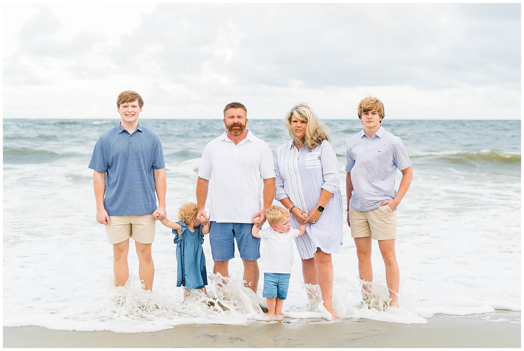Tybee sunset session family of 6 standing in the surf
