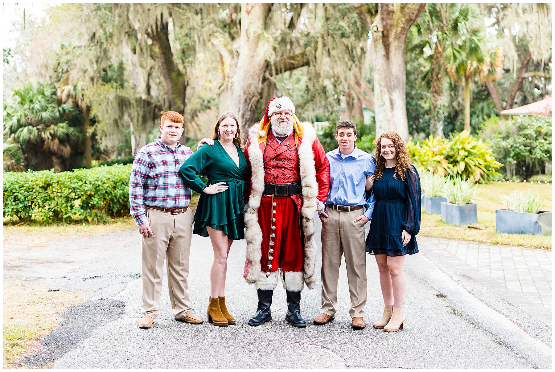 4 young adults standing with Santa on Isle of Hope's Bluff Drive for family photos