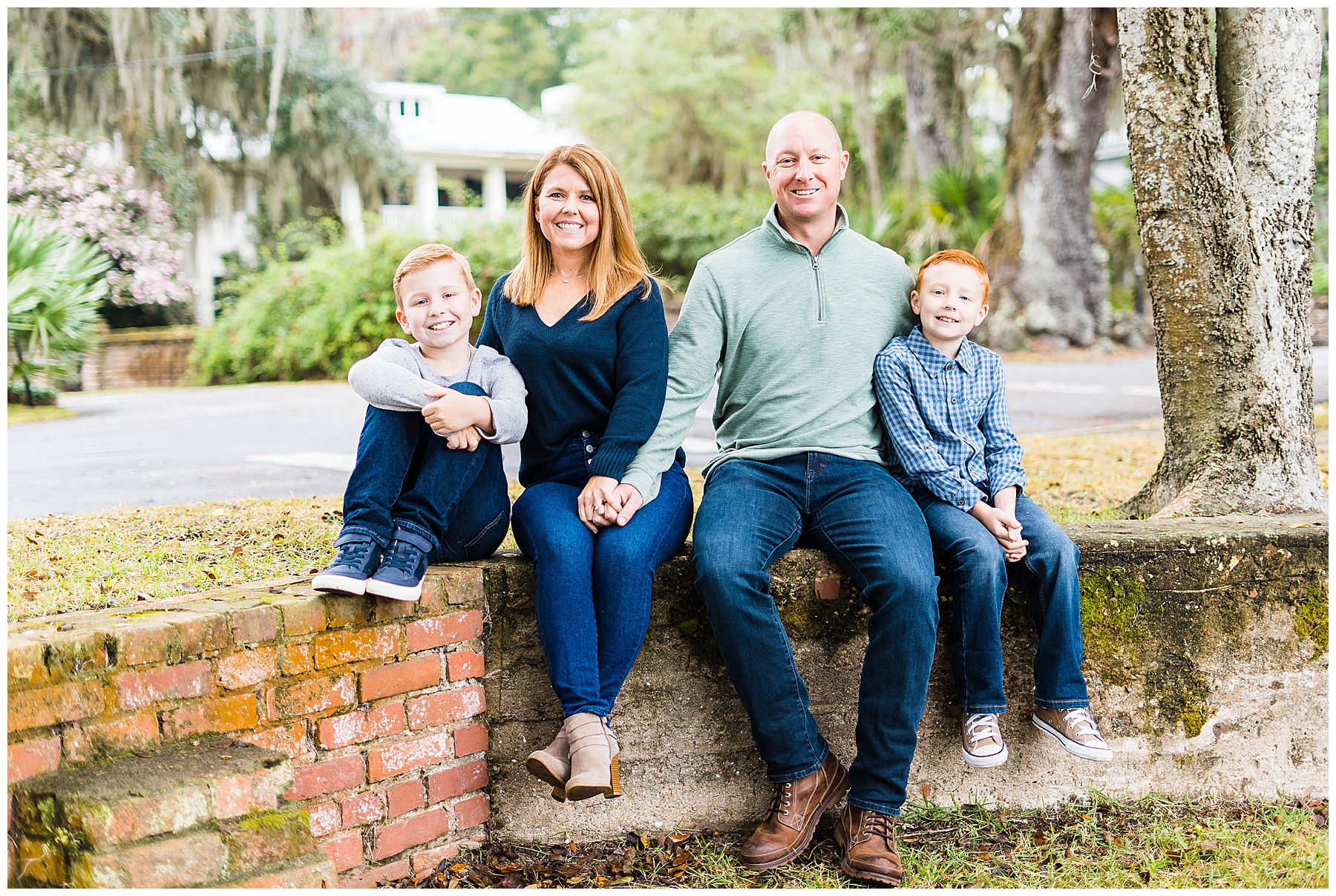 family of four sitting on a brick wall on Bluff Drive in Savannah Georgia