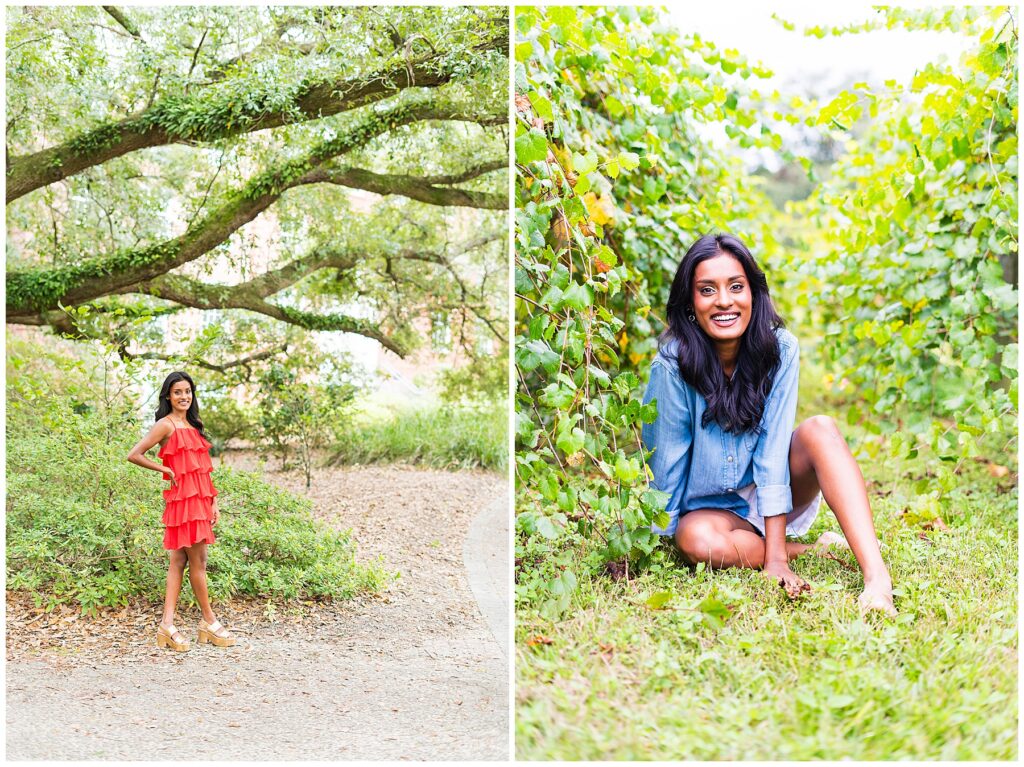 high school senior girl in red dress standing under oak trees and in blue shirt sitting in grape vines