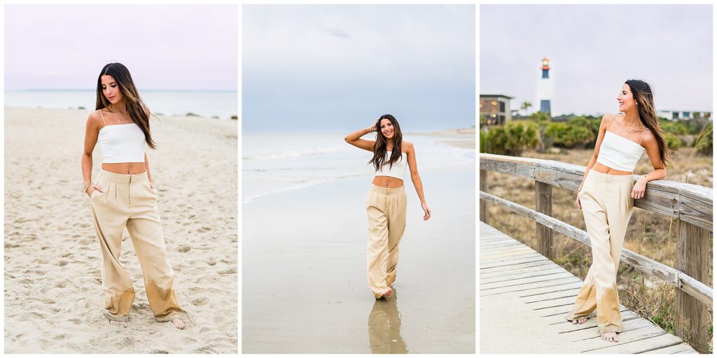 high school senior wearing khaki pants and a white top stands on Tybee Island beach having senior photos made