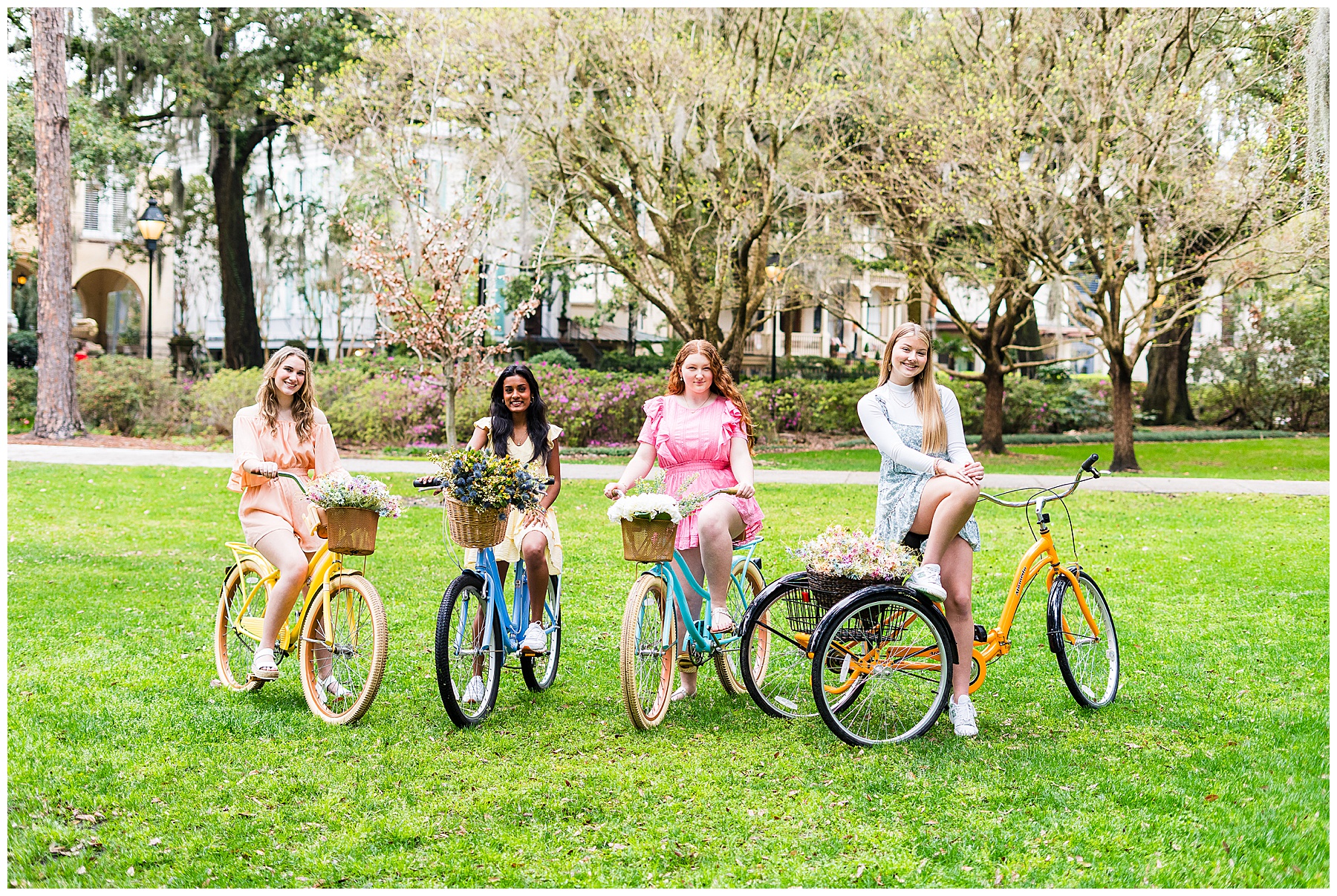 a group of high school senior girls posing with bicycles in Savannah, Georgia's Forsyth Park