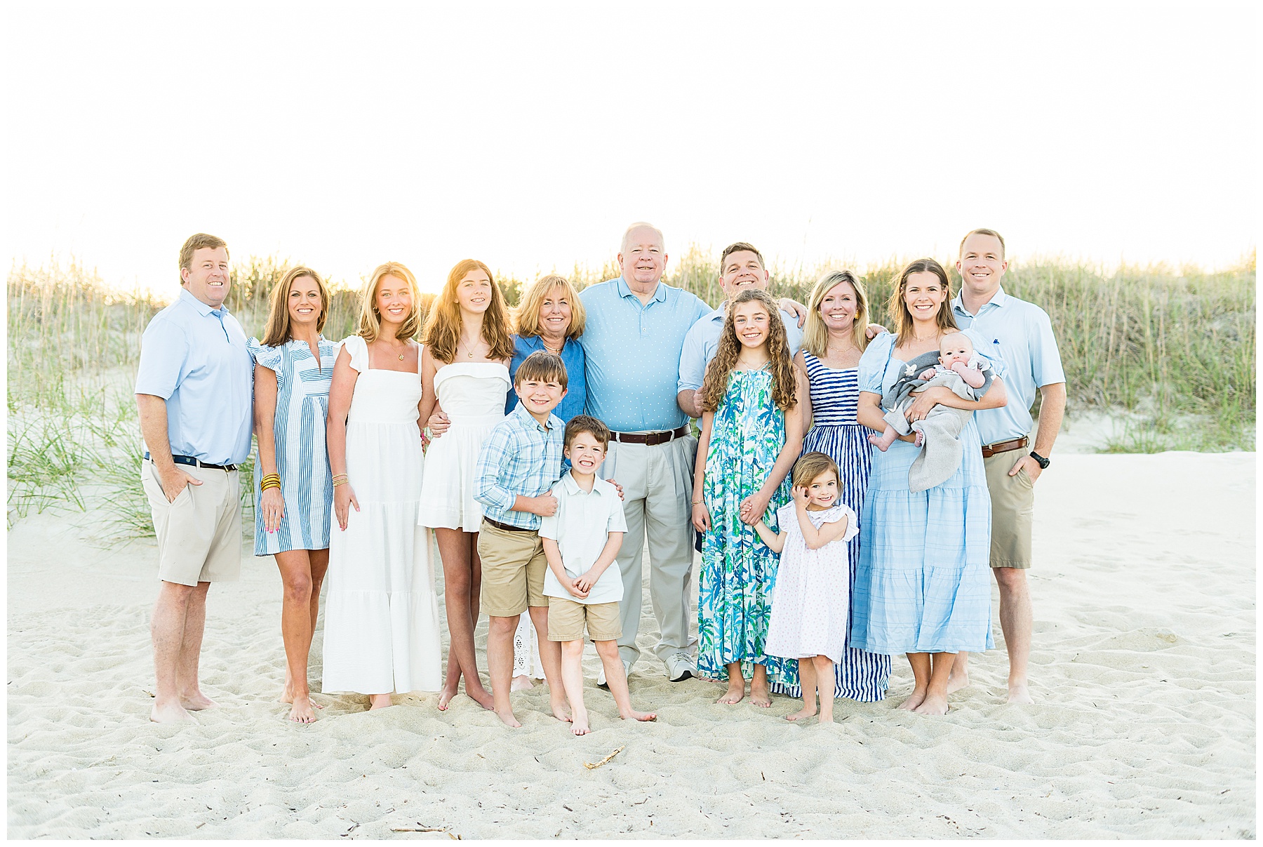 extended family standing on the beach around sunset for Tybee family photos