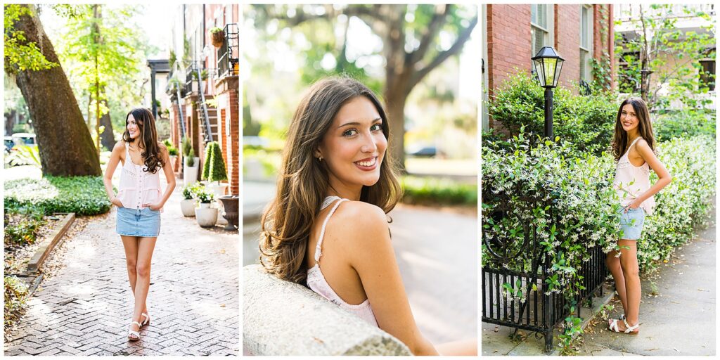 This collage features three bright and cheerful senior portraits of a young woman enjoying a sunny day in historic Savannah, Georgia. The warm lighting and blooming greenery create a fresh, springtime vibe. Left Photo: The senior is walking along a charming brick path lined with lush landscaping and classic Southern architecture. She’s wearing a light pink sleeveless top with lace detail and a denim mini skirt. Her long, wavy hair is styled down, and she’s smiling to the side with her hands casually in her pockets, giving off a confident and carefree energy. Center Photo: This close-up portrait captures the senior sitting on a stone bench, turned slightly to look back over her shoulder with a glowing smile. The background is softly blurred with green trees and dappled sunlight, highlighting her natural beauty and joyful expression. Right Photo: She’s standing next to a wrought-iron fence draped in flowering vines, possibly jasmine, which adds a romantic and whimsical feel. Her outfit now includes denim shorts paired with the same pink top, and she’s wearing white sandals. She leans casually against the fence, smiling warmly at the camera.