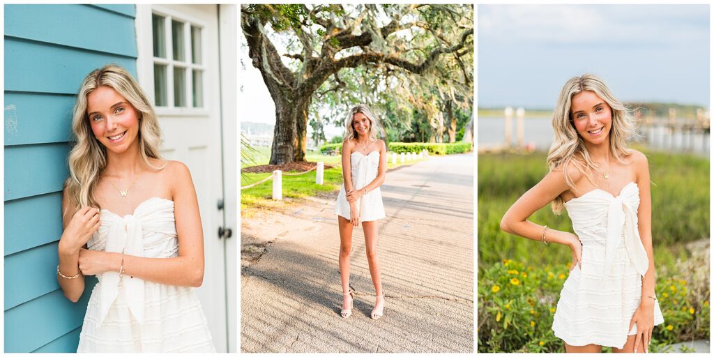 This collage includes three senior portraits that highlight a bright, summery look in various charming outdoor settings:

Left Image:
The senior is leaning against a turquoise clapboard wall next to a white door, creating a fresh, coastal feel. She’s smiling warmly at the camera, her hand gently playing with her hair. She wears a strapless white textured romper with a large bow detail at the front, paired with minimal jewelry, including a gold “W” necklace and a delicate bracelet.
Center Image:
She stands in the middle of a sunlit road lined with oak trees draped in Spanish moss. Her relaxed stance, soft smile, and gently clasped hands give the image a graceful, easygoing tone. The golden-hour light beautifully highlights her outfit and surroundings.
Right Image:
The senior poses near a marsh with yellow wildflowers and a dock in the background. With one hand on her hip and the other resting casually at her side, she smiles confidently at the camera. The light wind and natural setting add a soft sense of movement and serenity to the portrait.