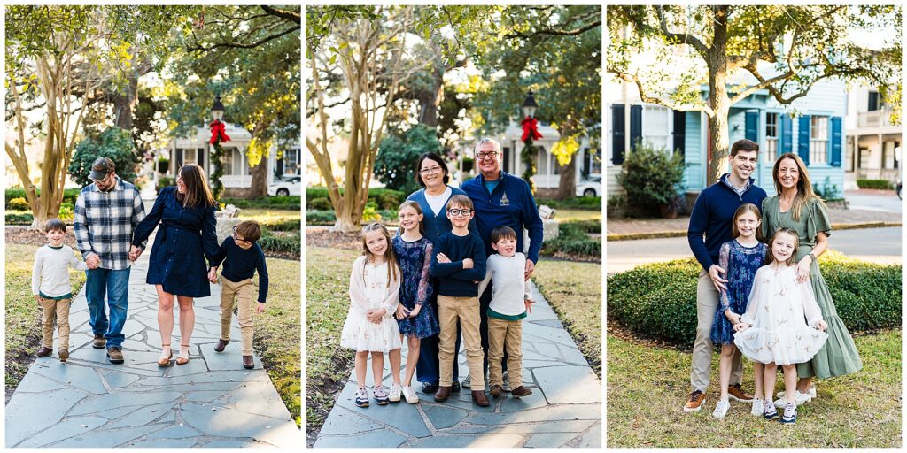 This is a three-panel collage of family portraits photographed in a charming neighborhood park setting, featuring a mix of candid walking moments and classic posed family groupings. The images have a warm, connected feel with soft winter or holiday-season touches in the background. Left photo: A family of four walks together down a stone pathway lined with grass and mature trees. The parents walk in the center holding hands with their two young boys. The father wears a gray-and-blue plaid shirt with jeans and a baseball cap, while the mother wears a navy long-sleeve dress with heels. One son walks confidently beside them, while the other leans playfully toward his mom, adding movement and personality to the image. In the background, there are neighborhood homes and a lamp post decorated with a red holiday bow, suggesting a festive season. Middle photo: A multi-generational family portrait features grandparents standing behind four grandchildren on the same stone pathway. The grandparents smile warmly while the children stand in front in coordinated outfits of navy, cream, and khaki tones. The kids’ expressions and poses feel relaxed and natural — one boy folds his arms confidently while the younger child smiles brightly. The holiday bow in the background and soft afternoon light give the portrait a cozy, seasonal feel. Right photo: A family of four poses together in front of charming neighborhood homes and large trees. The father wears a navy sweater with khaki pants, while the mother wears a flowing sage-green dress. Their two daughters stand in front wearing dresses in soft neutral and navy floral patterns. One girl holds out the skirt of her dress slightly, adding a playful touch. The family stands close together, smiling warmly at the camera. Overall, the collage feels warm, timeless, and connection-focused, with a classic Savannah neighborhood aesthetic — tree-lined streets, charming homes, soft natural light, and subtle seasonal details. The coordinated wardrobe palette of navy, greens, creams, and khakis helps the images feel cohesive without looking overly matched.